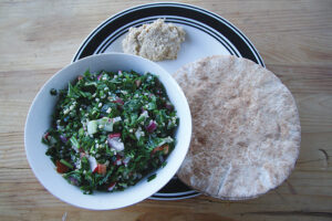 Tabbouleh with pita bread and a dollop of hummus.